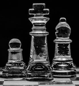 Clear Chess Set on a Black Background with a Checkboard floor